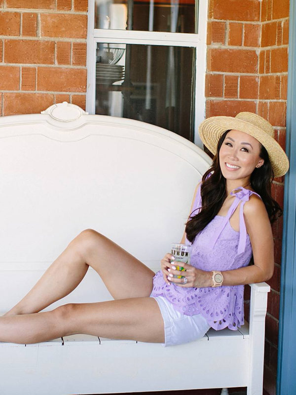 diana Elizabeth blogger on white bench holding lemonade