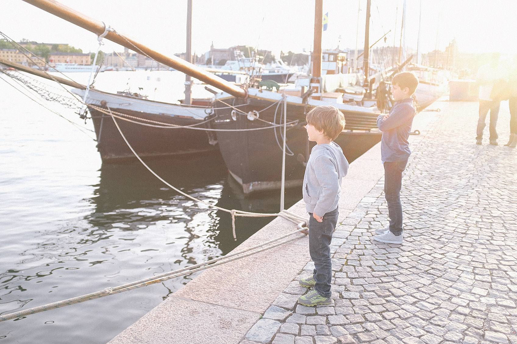 Photo tour of Stockholm: by the ocean ships boys watching a small boat go by
