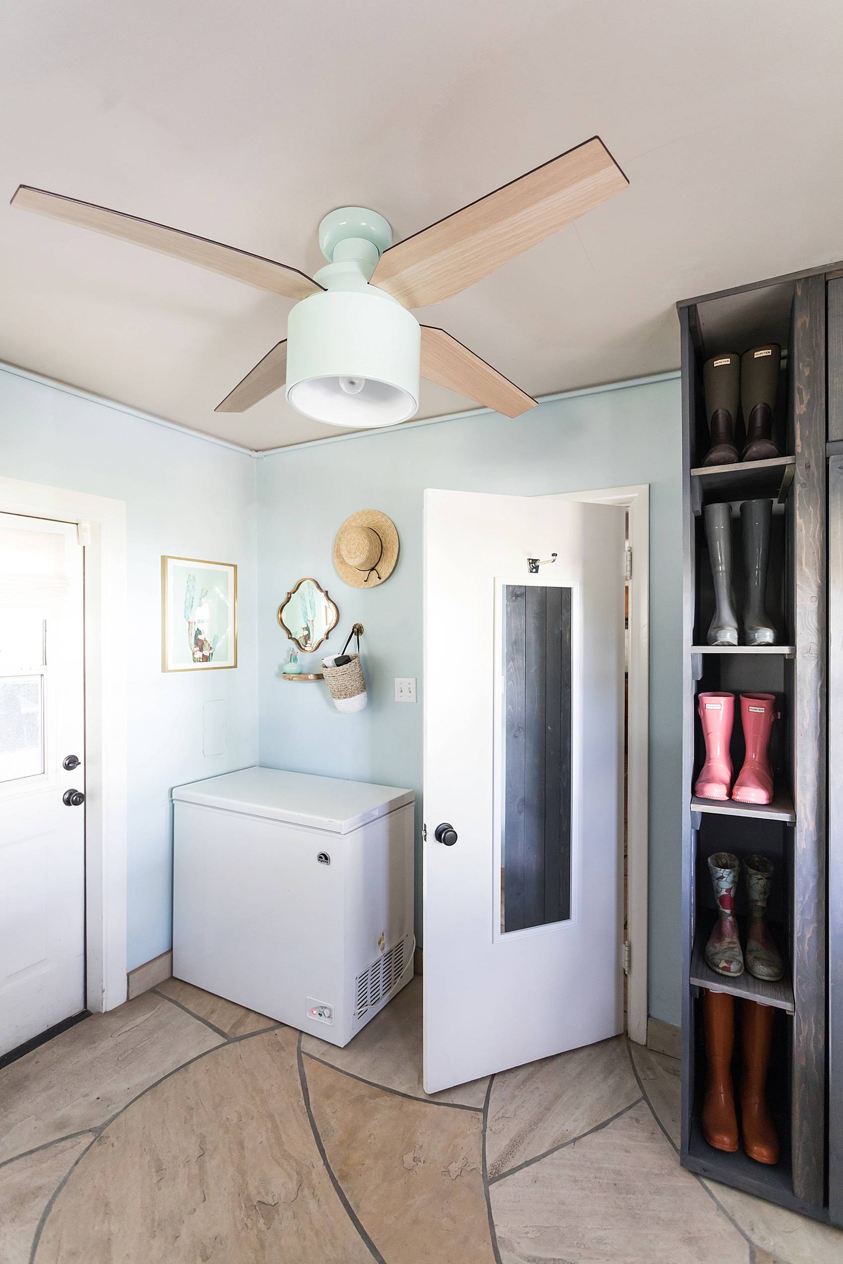 laundry mud room with custom cabinets rustic look with blue removable wallpaper in background and mint hunter fan Ikea cactus hunter boots display full length mirror