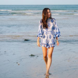 Lifestyle blogger Diana Elizabeth in Puerto Penasco Rocky Point Mexico in water wearing blue and white tassel romper