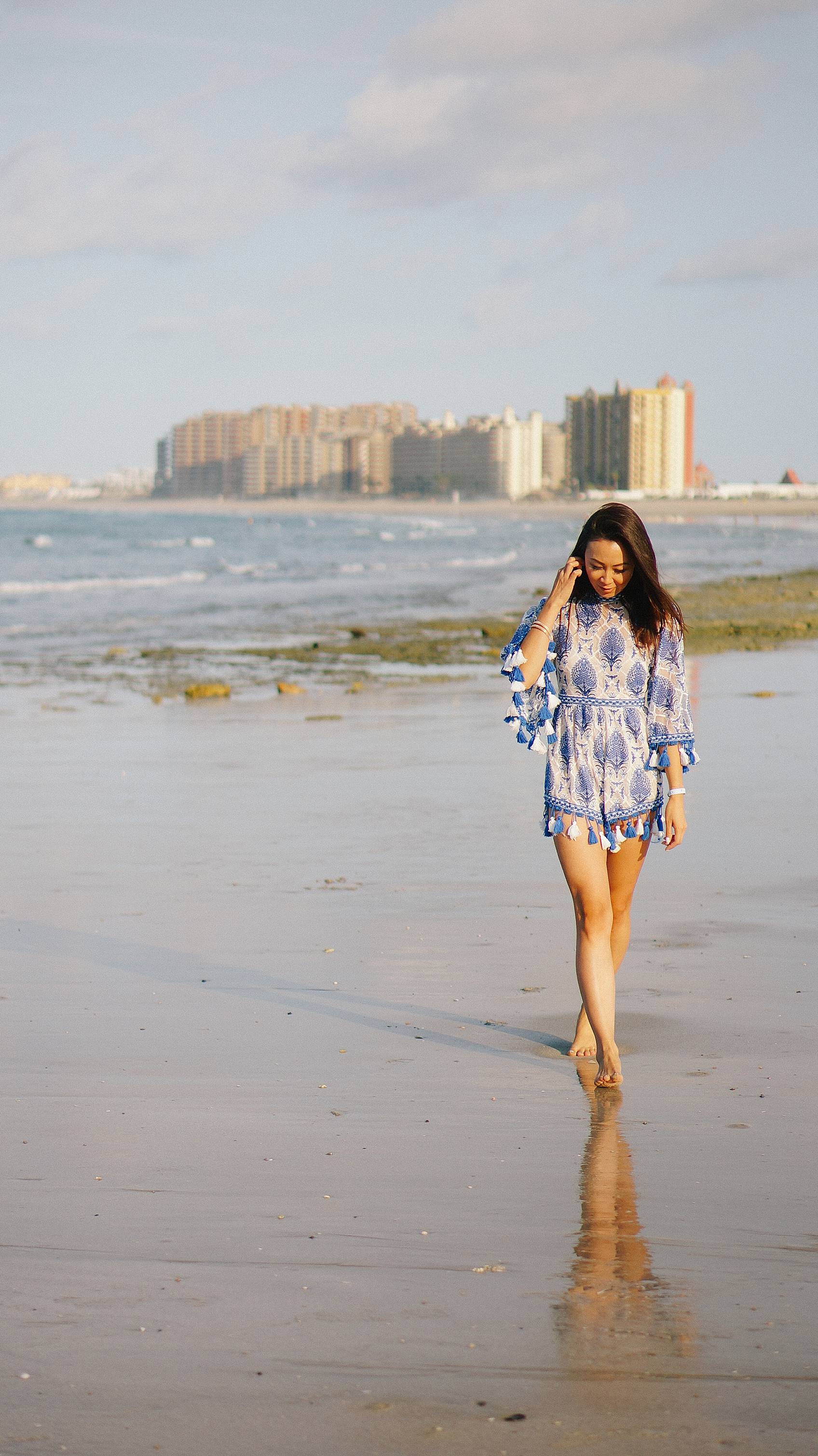 Lifestyle blogger Diana Elizabeth in Puerto Penasco Rocky Point Mexico in water wearing blue and white tassel romper
