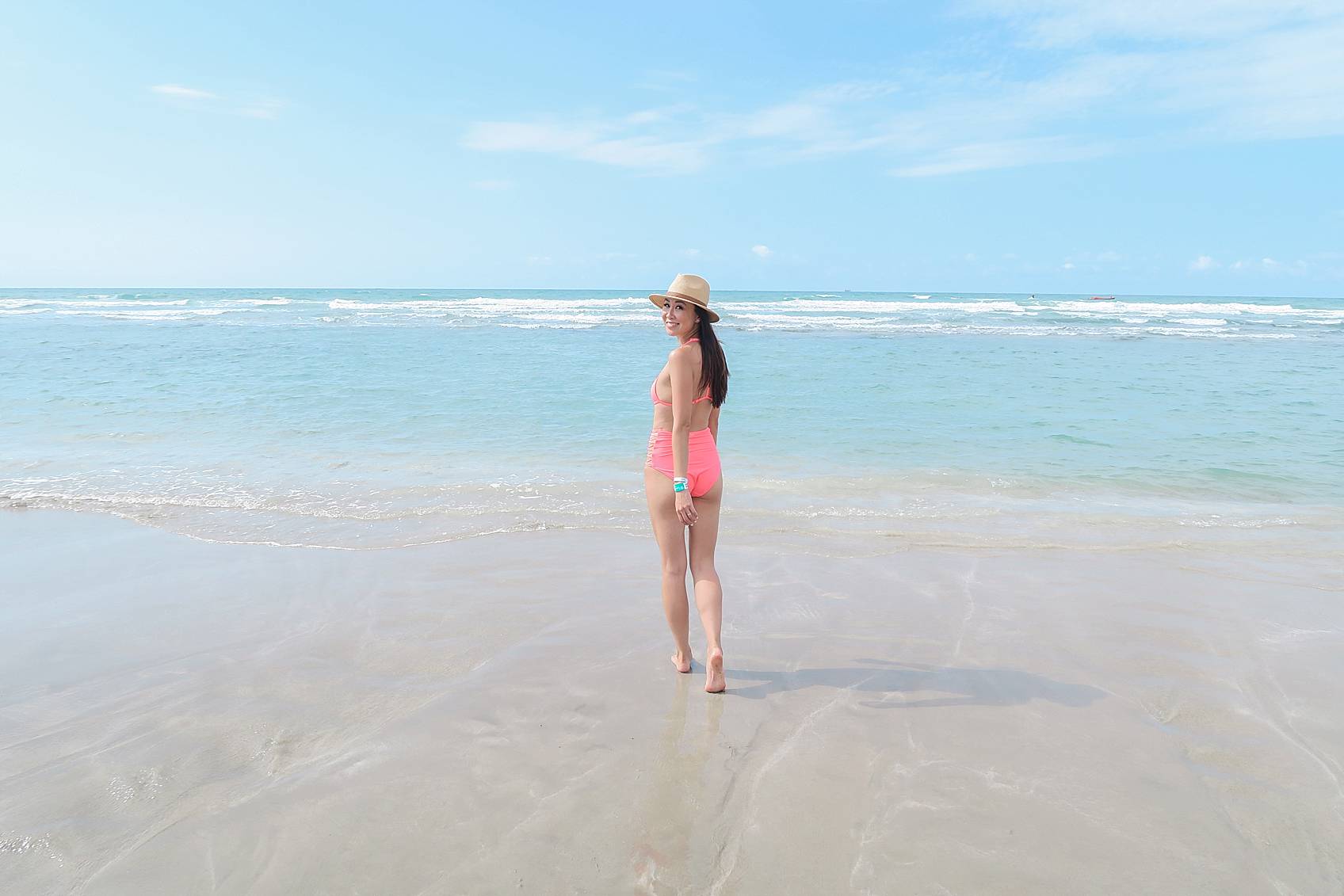 Lifestyle blogger Diana Elizabeth in Puerto Penasco Rocky Point Mexico in water wearing hot pink high waist bikini
