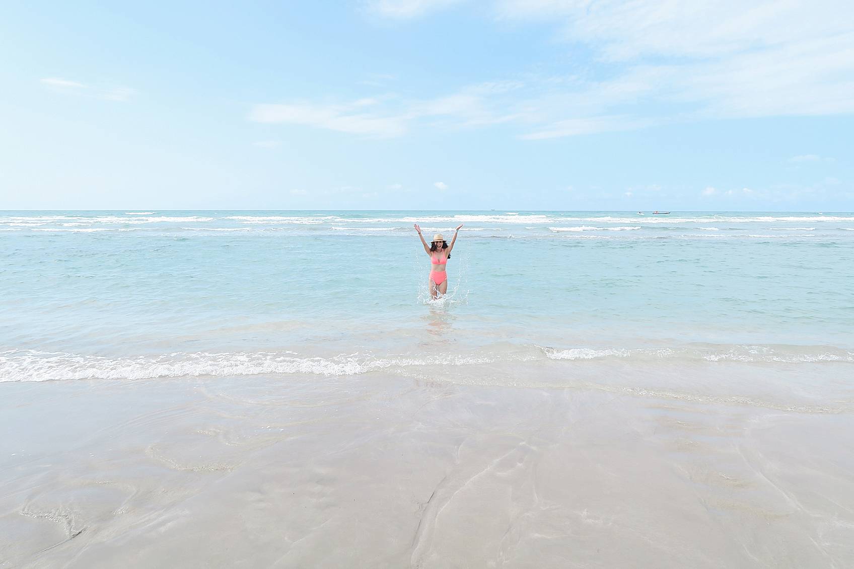 Lifestyle blogger Diana Elizabeth in Puerto Penasco Rocky Point Mexico in water wearing hot pink high waist bikini