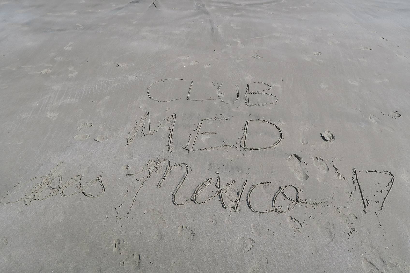 Club MED written in sand