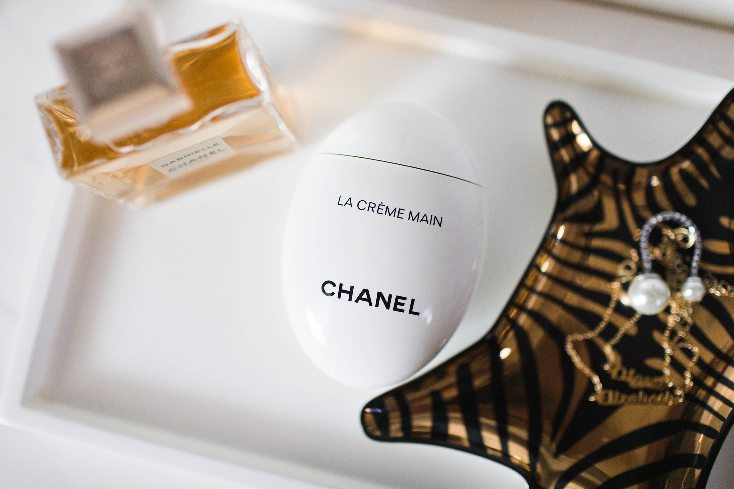 Chanel la Creme Main hand cream on beauty tray with zebra tray by jonathan Adler