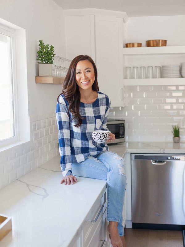 blue white checker top anthropology ripped jeans sitting on top of kitchen counter