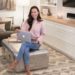 pink sweater ankle jeans sitting on coffee table Wireless router by Norton Core security fits well into home decor