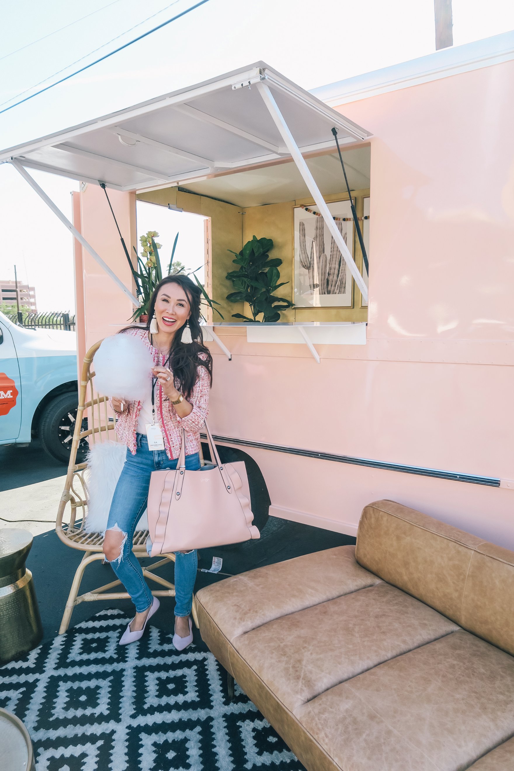 standing by the peach az restored truck in pink boucle jacket ripped jeans and holding cotton candy // a business and blogging social media workshop called The Workshop PHX by the Bloguettes - a review.