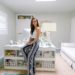 blogger photographer home office decor Diana Elizabeth - wearing white top with blue and white stripe pants sitting on Coastal Living by Stanley Furniture Oasis Cape Dutch Writing Desk