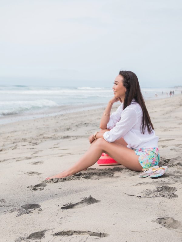 Carlsbad state beach wearing Lilly Pulitzer ocean view boardshort Diana Elizabeth blogger sitting on beach