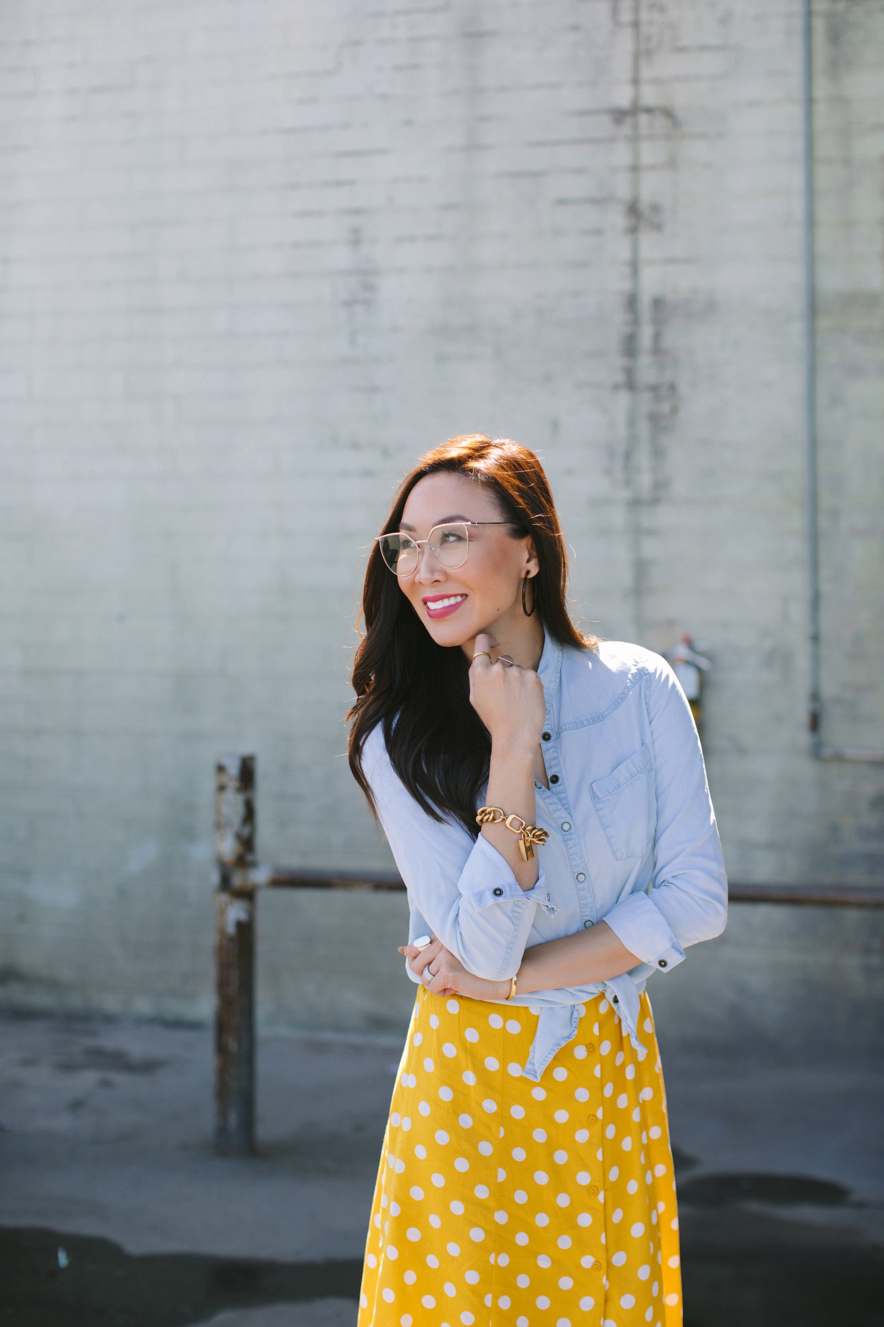 Yellow and white polka dot dress forever 21 paired with a chambray top featuring India hicks bracelet and other jewels lifestyle blogger Diana Elizabeth also wearing clear sunglases