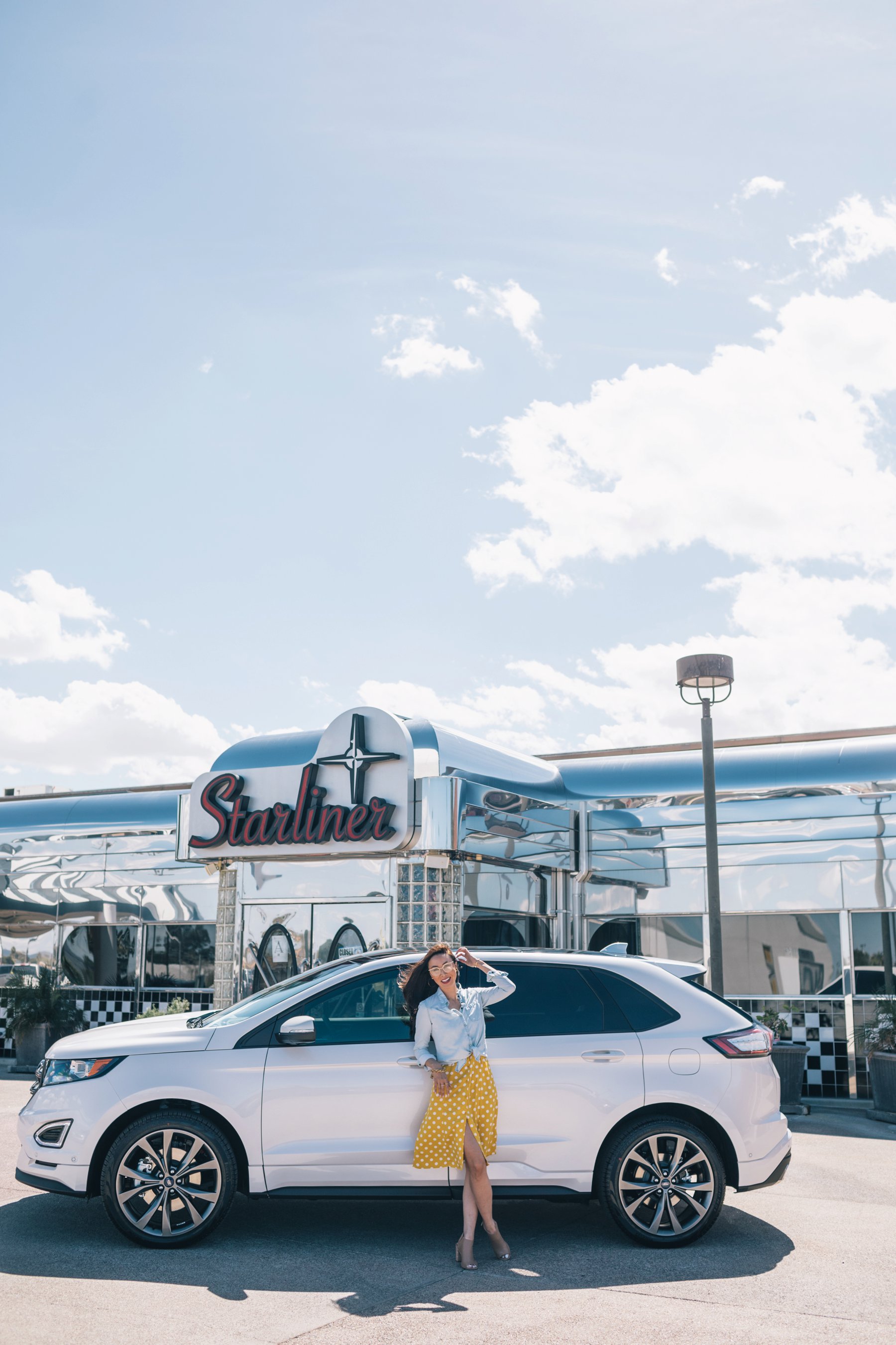 Ford Edge review with Sanderson Ford, lifestyle blogger Diana Elizabeth posing with a car