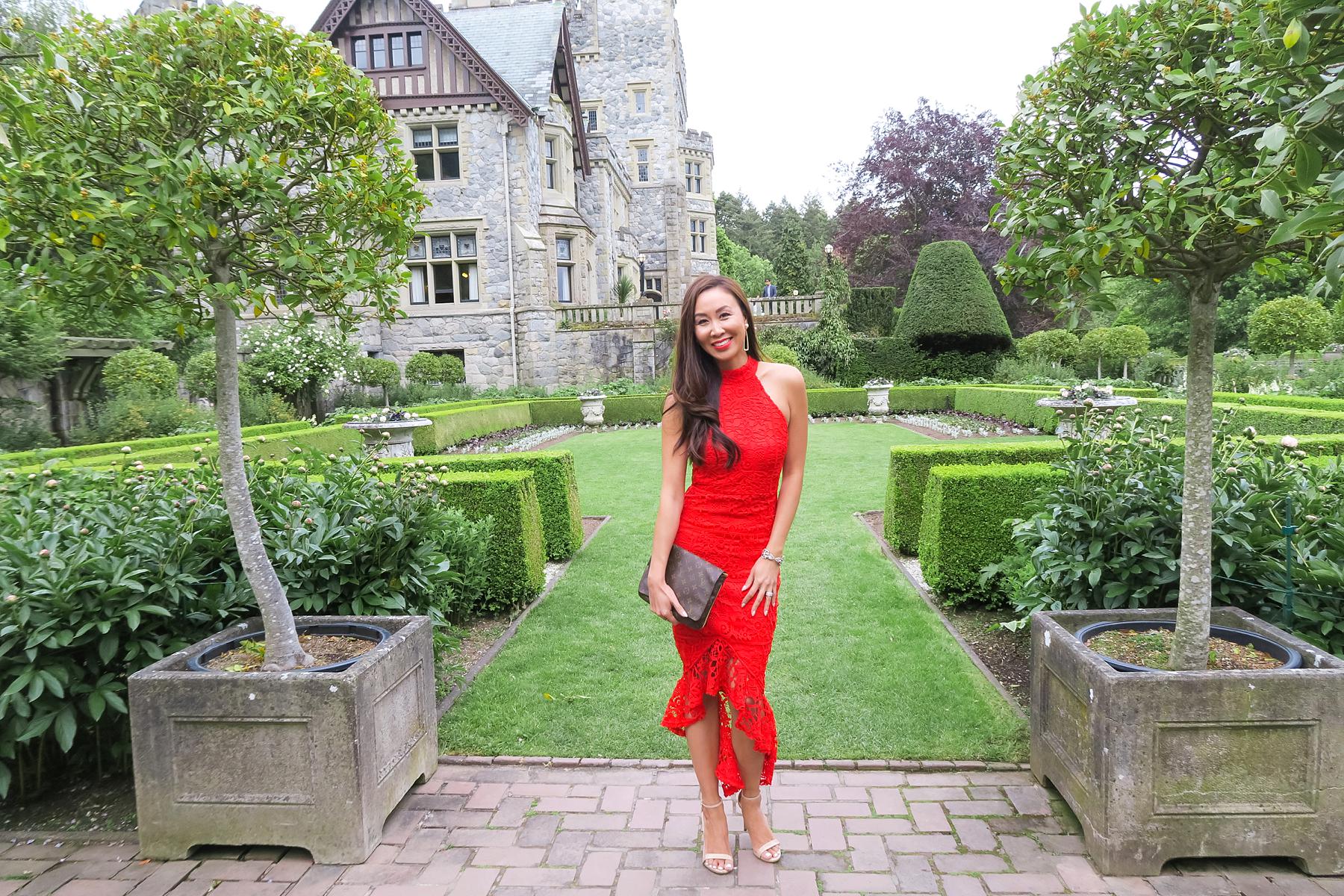 wedding at hatley castle wedding in Victoria Canada wearing a red lace dress like the emoji