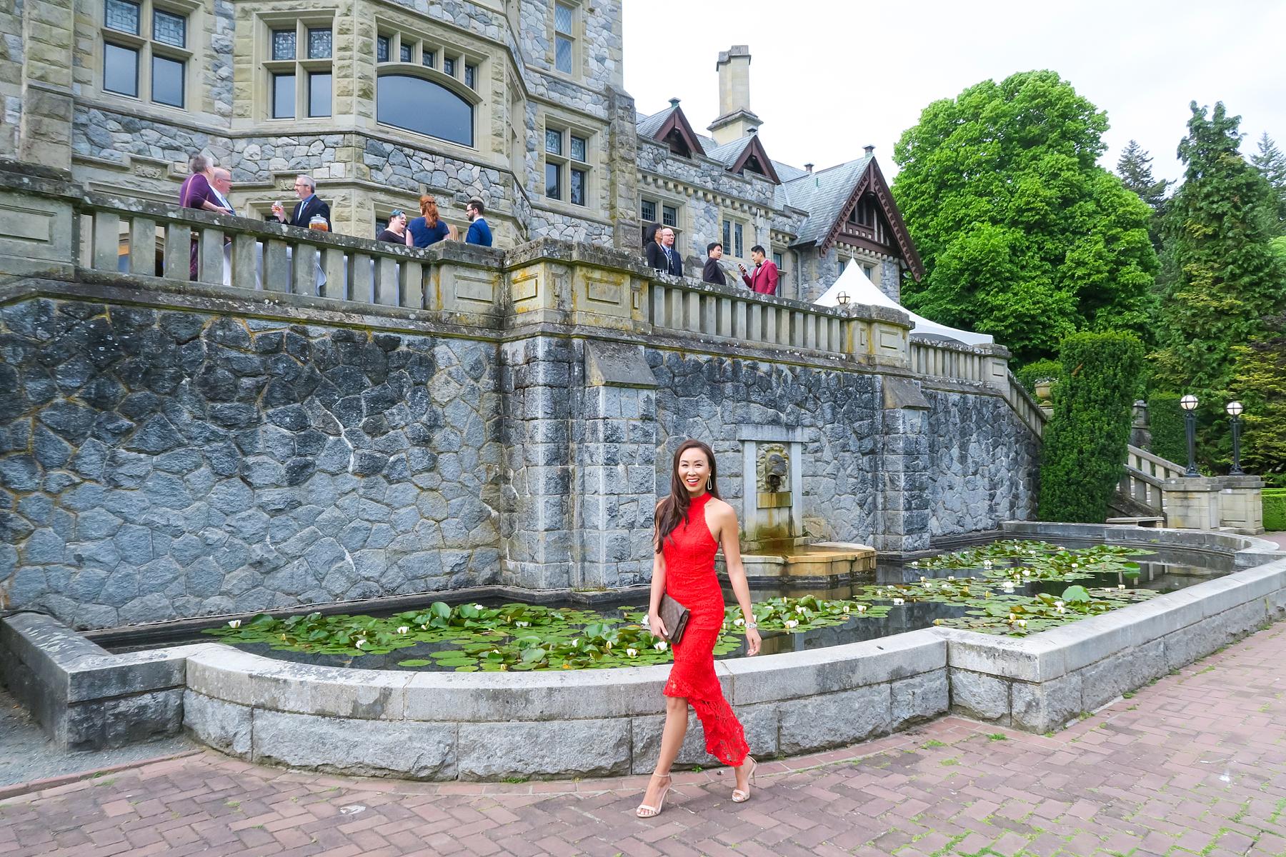 wedding at hatley castle wedding in Victoria Canada wearing a red lace dress like the emoji