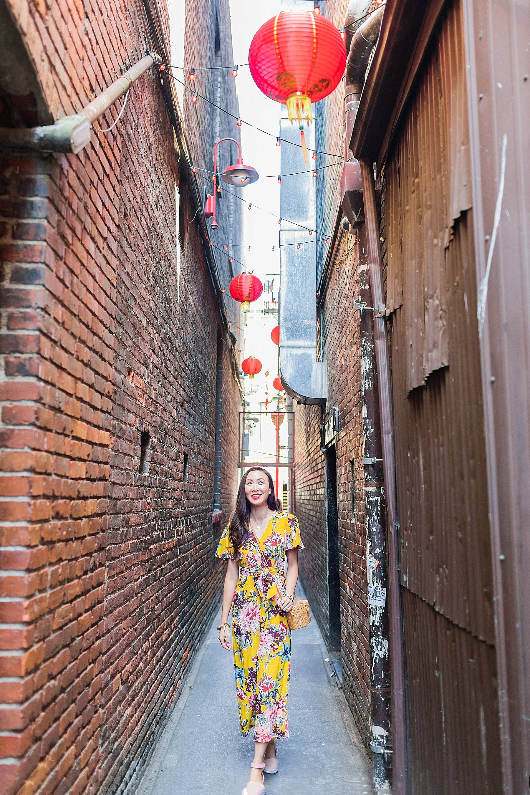 fan tan alley in Victoria Canada chinatown wearing yellow floral jumpsuit by Tahari ASL