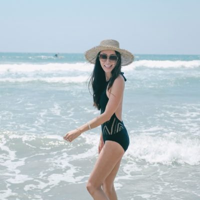 Solana beach San Diego California one piece lace cutout swimsuit lack of colors straw hat lifestyle blogger Diana Elizabeth in ocean