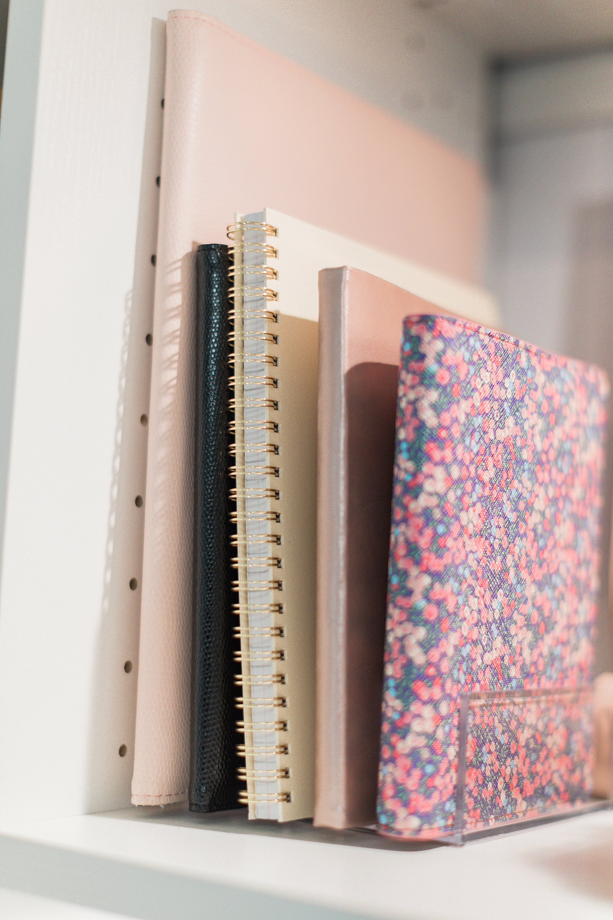 business notebooks on hand for meetings: final reveal of office closet reveal belonging to photographer blogger Diana Elizabeth in phoenix arizona. created by California closets and with removable buffalo check wallpaper #office #closet #wallpaper #organization #lensorganization #lensdrawer