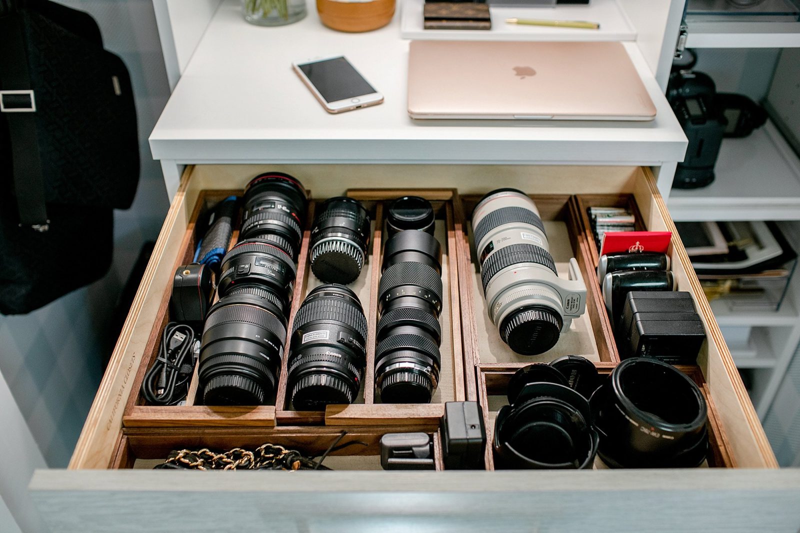 camera lens drawer in photographer's office. see how to organize camera lenses in drawers