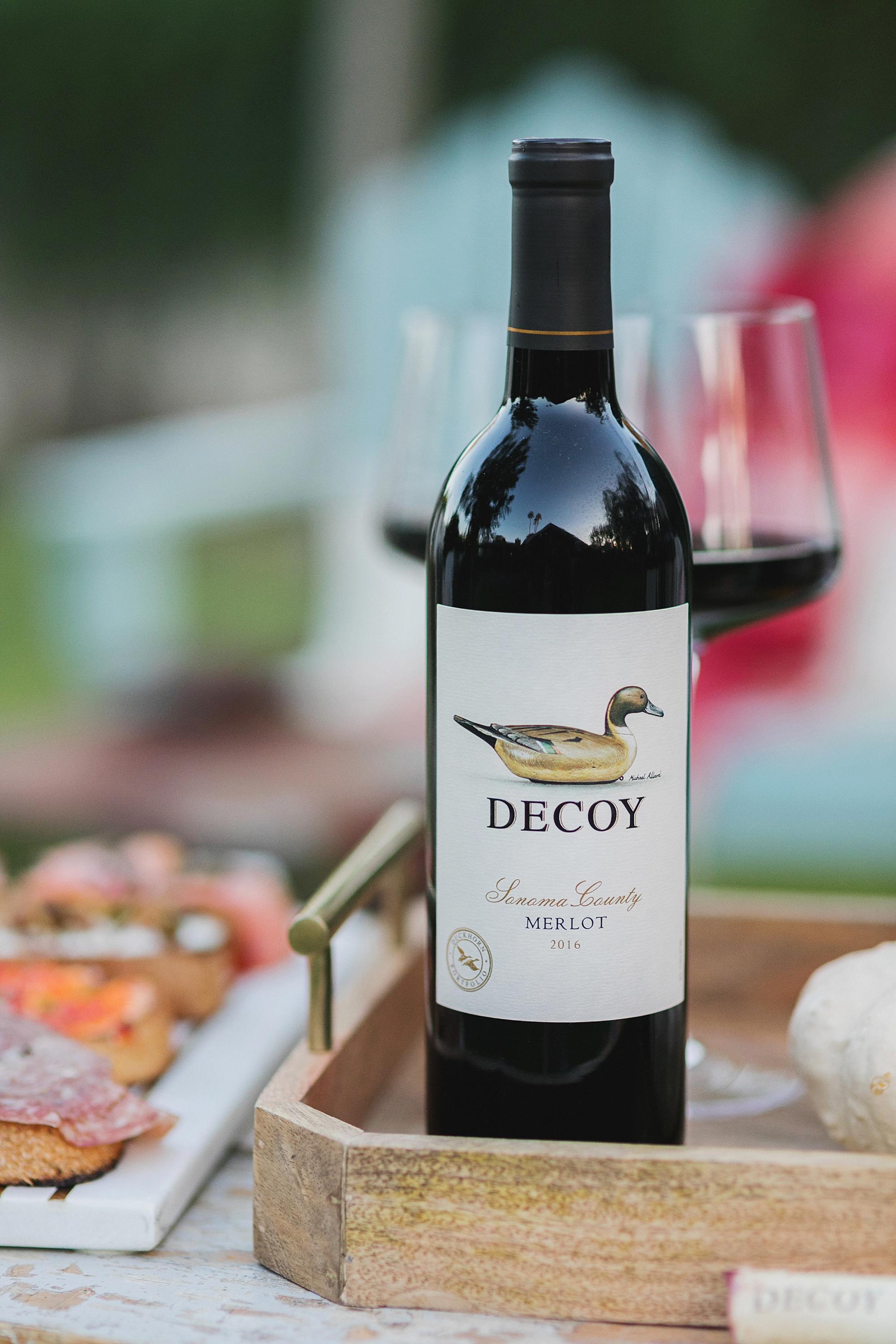 decoy wine merlot to celebrate merlot month of October! backyard setup with fire pit and bruschetta boards with blogger Diana Elizabeth - hay bales pumpkins, gourds and cozy blankets and pillows