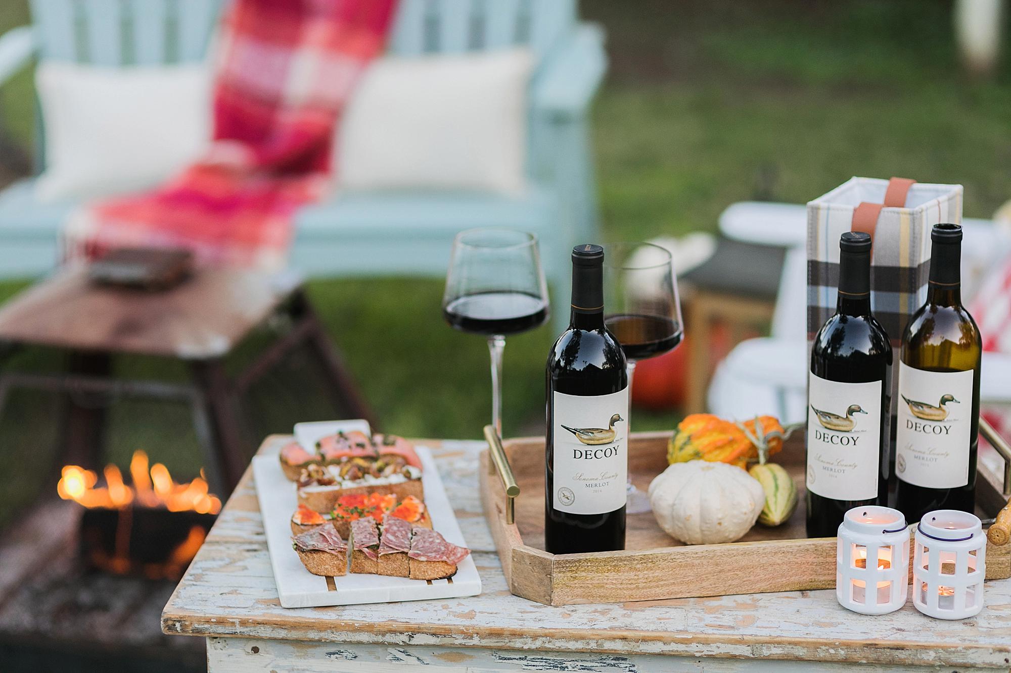 merlot decoy wine for merlot month in October. fire pit for fall gathering outdoors and bruschetta board for wine