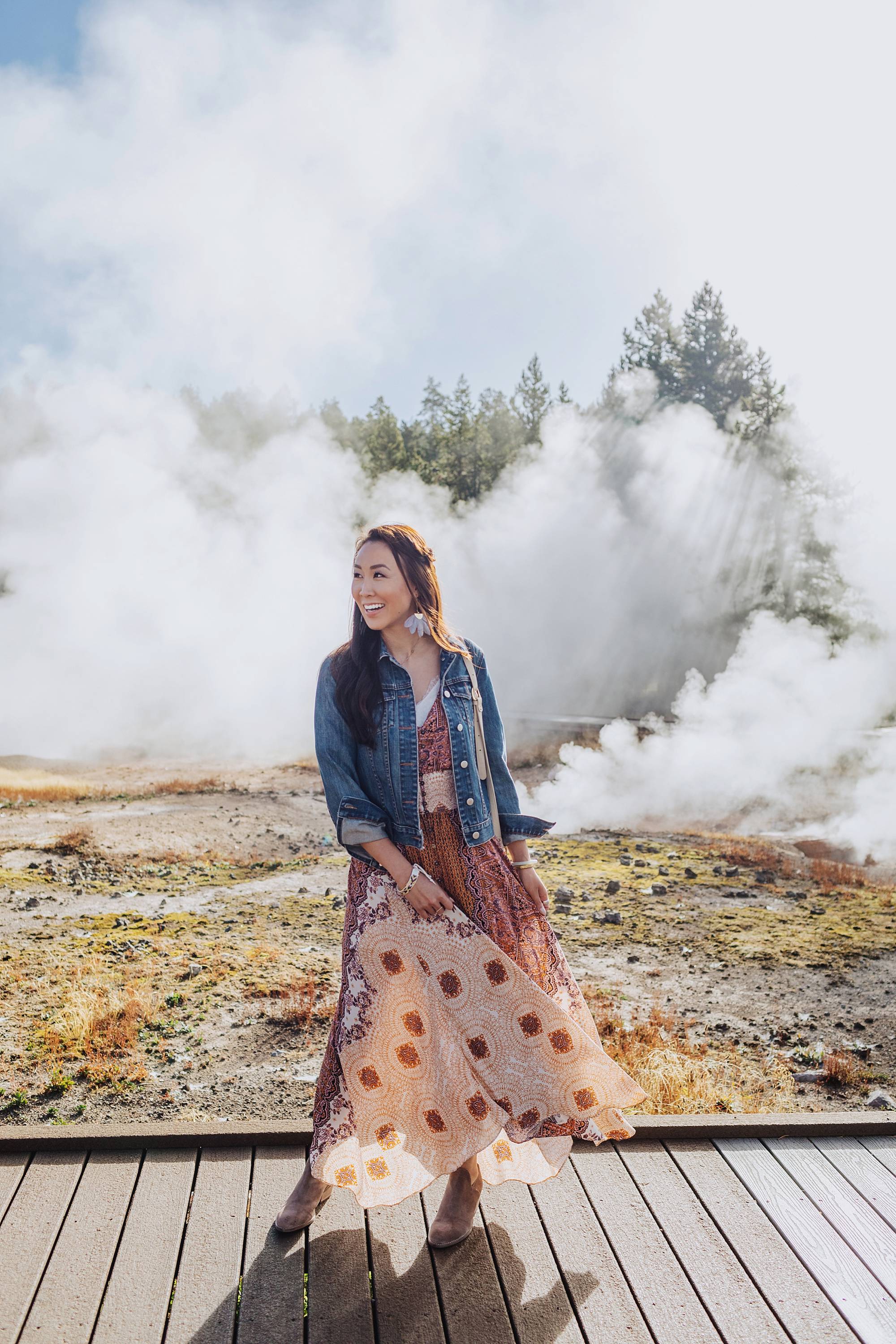 Yellowstone geysers, lifestyle blogger Diana Elizabeth in free people dress from Macy's and lucky brand booties wearing denim jacket. travel fashion inspiration post