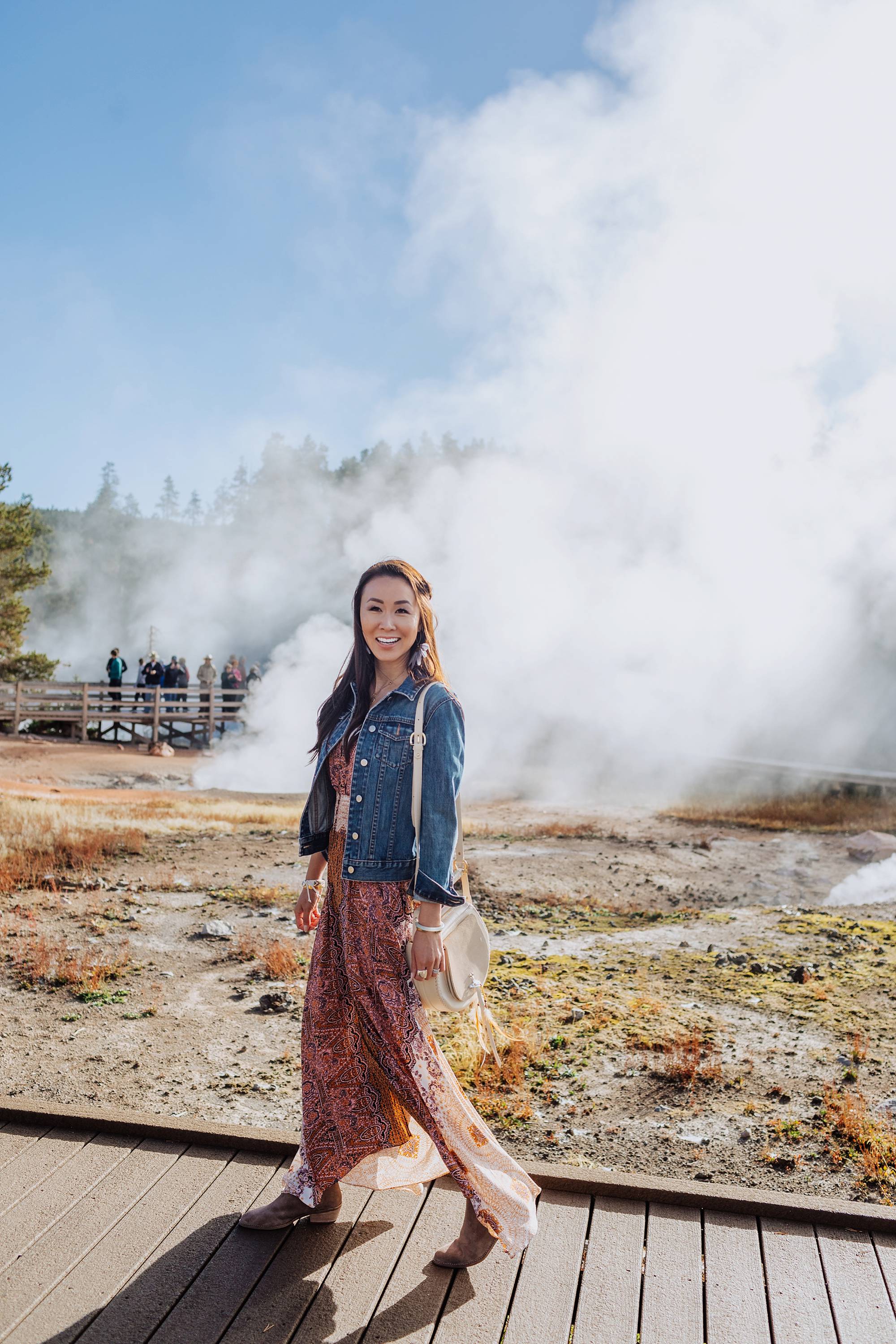 Yellowstone geysers, lifestyle blogger Diana Elizabeth in free people dress from Macy's and lucky brand booties wearing denim jacket. travel fashion inspiration post