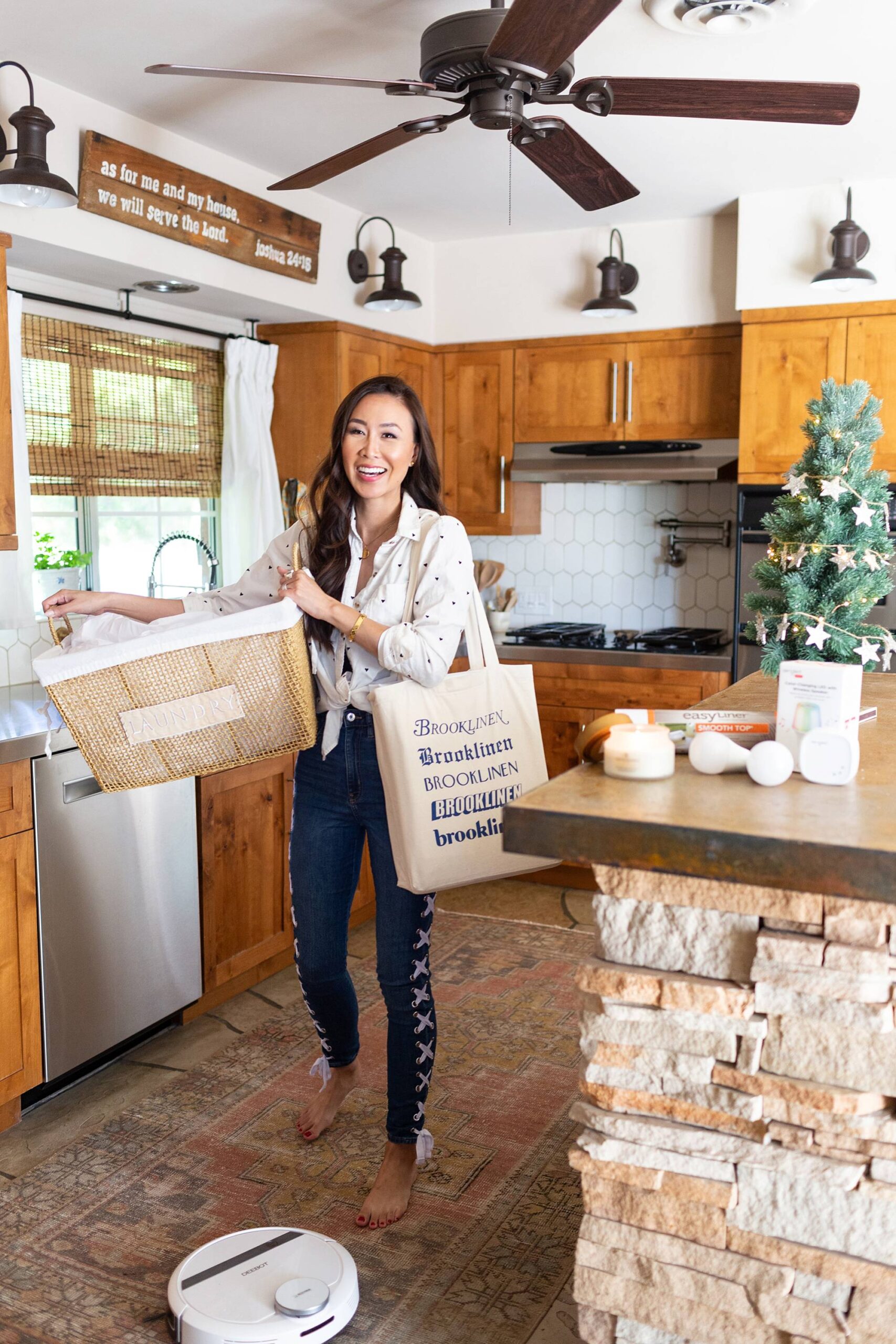 lifestyle blogger holding basket of laundry and some goodies in a babbleboxx getting home ready for thanksgiving and the holidays #kitchengoals #Kitchen