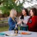 santa margherita prosecco superiore set by mylar alphabet balloons and the an outdoor pizza fireplace lifestyle blogger Diana Elizabeth in phoenix arizona toasting with friends