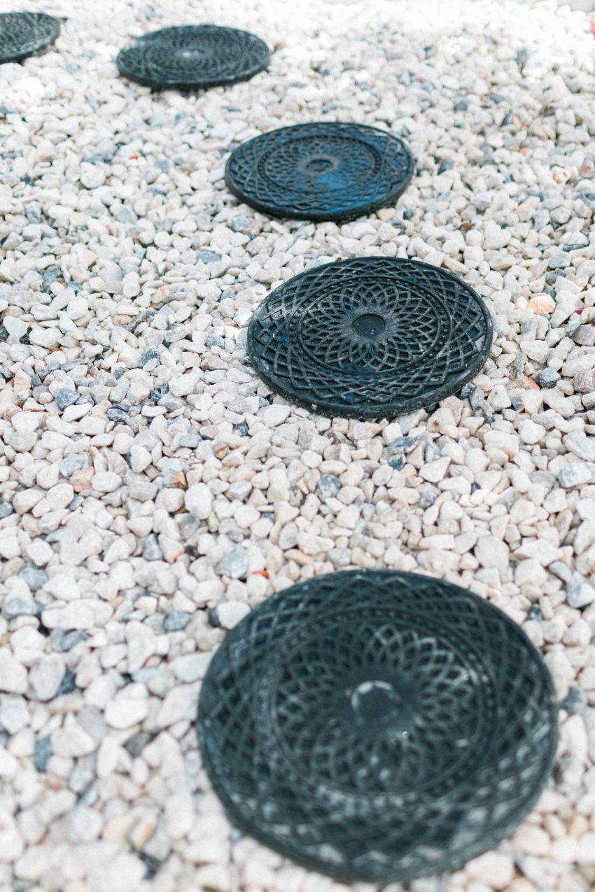 make a rocky drainage path for areas that get muddy by the hose or in the garden - a DIY how too. Alabaster white sherwin Williams white fiber cement shake shingles for siding, restoration hardware lights