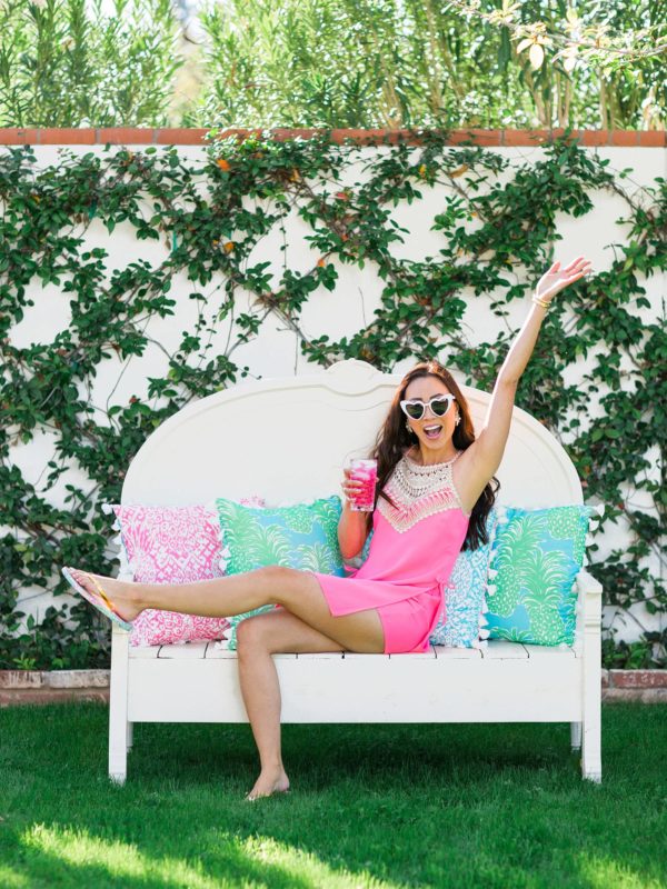 Lilly Pulitzer x Pottery Barn collaboration Spring summer 2019 on white bench with lilly Pulitzer outdoor pillows