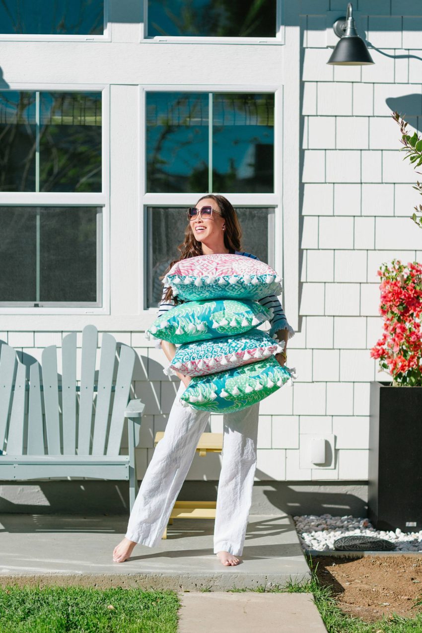 Lilly Pulitzer x Pottery Barn collaboration Spring summer 2019 on white bench with lilly Pulitzer outdoor pillows