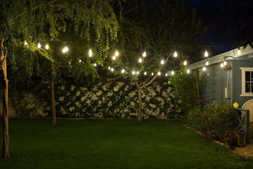 how to hang cafe string lights on cable wire in backyard - easy DIY and all the materials you need