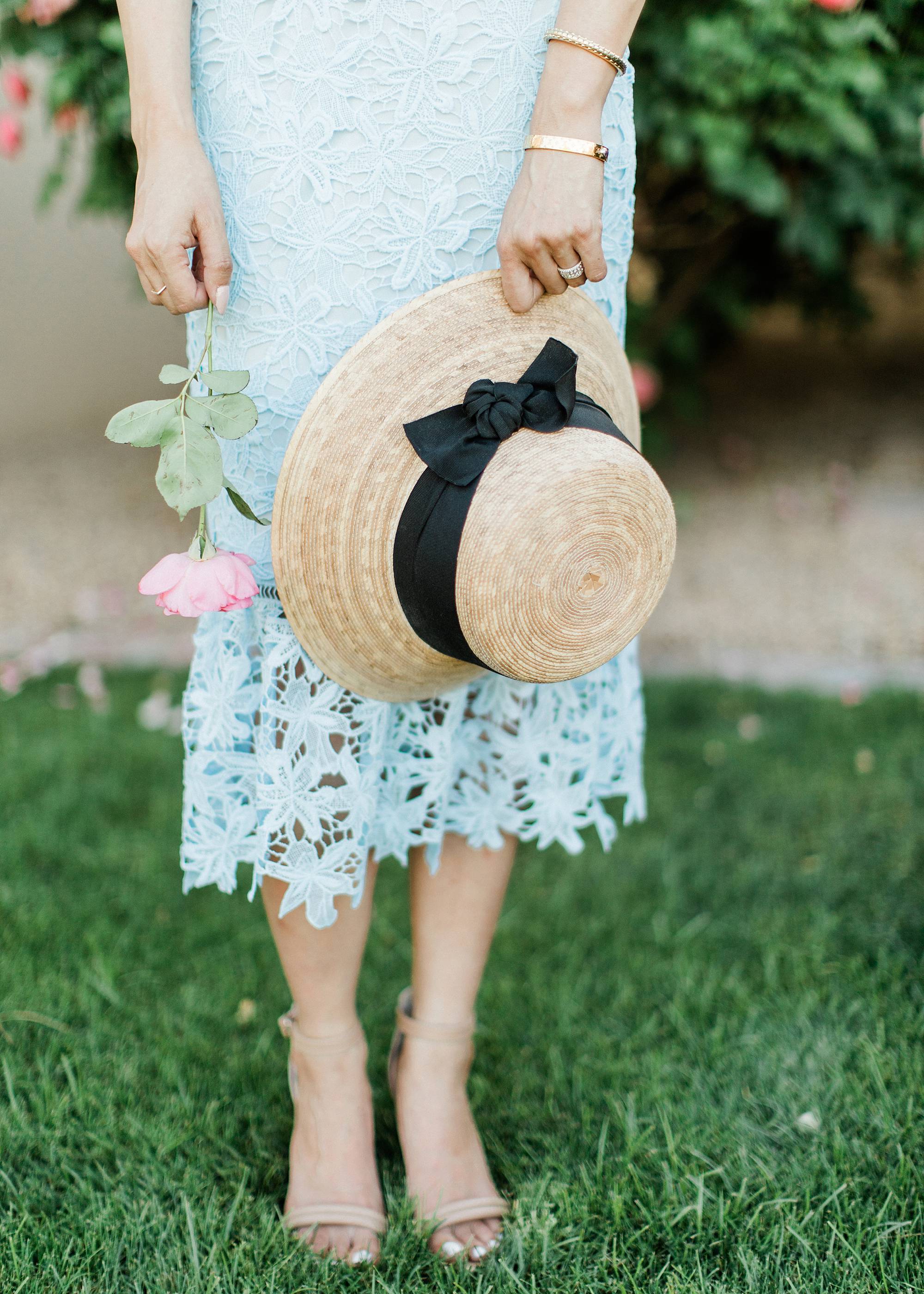blue lace dress with garden hat from terrain nestled between pink roses against the wall - lifestyle blogger Diana Elizabeth phoenix scottsdale arizona