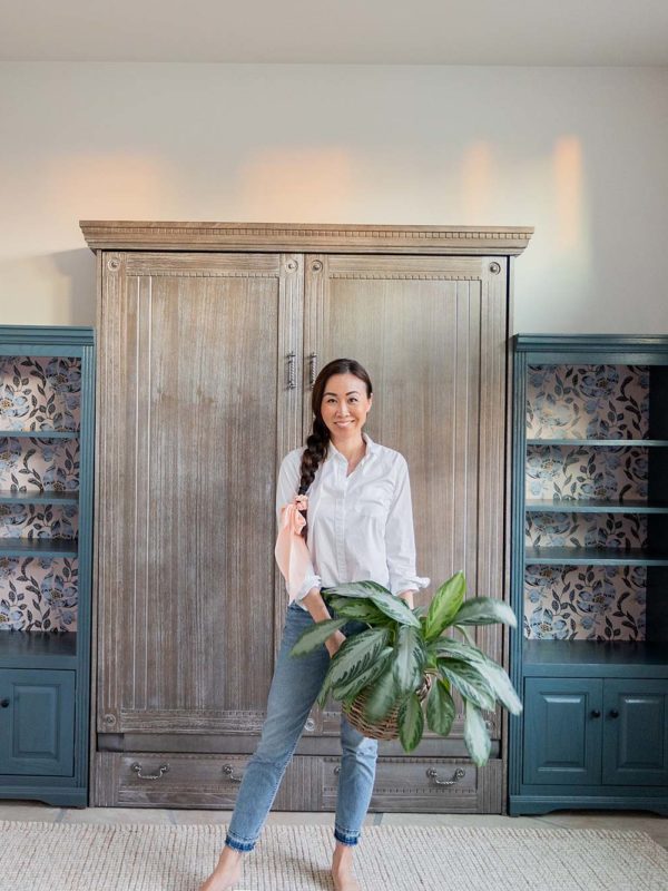 phoenix home blogger Diana Elizabeth in front of Murphy bed with bookshelves and wallpaper