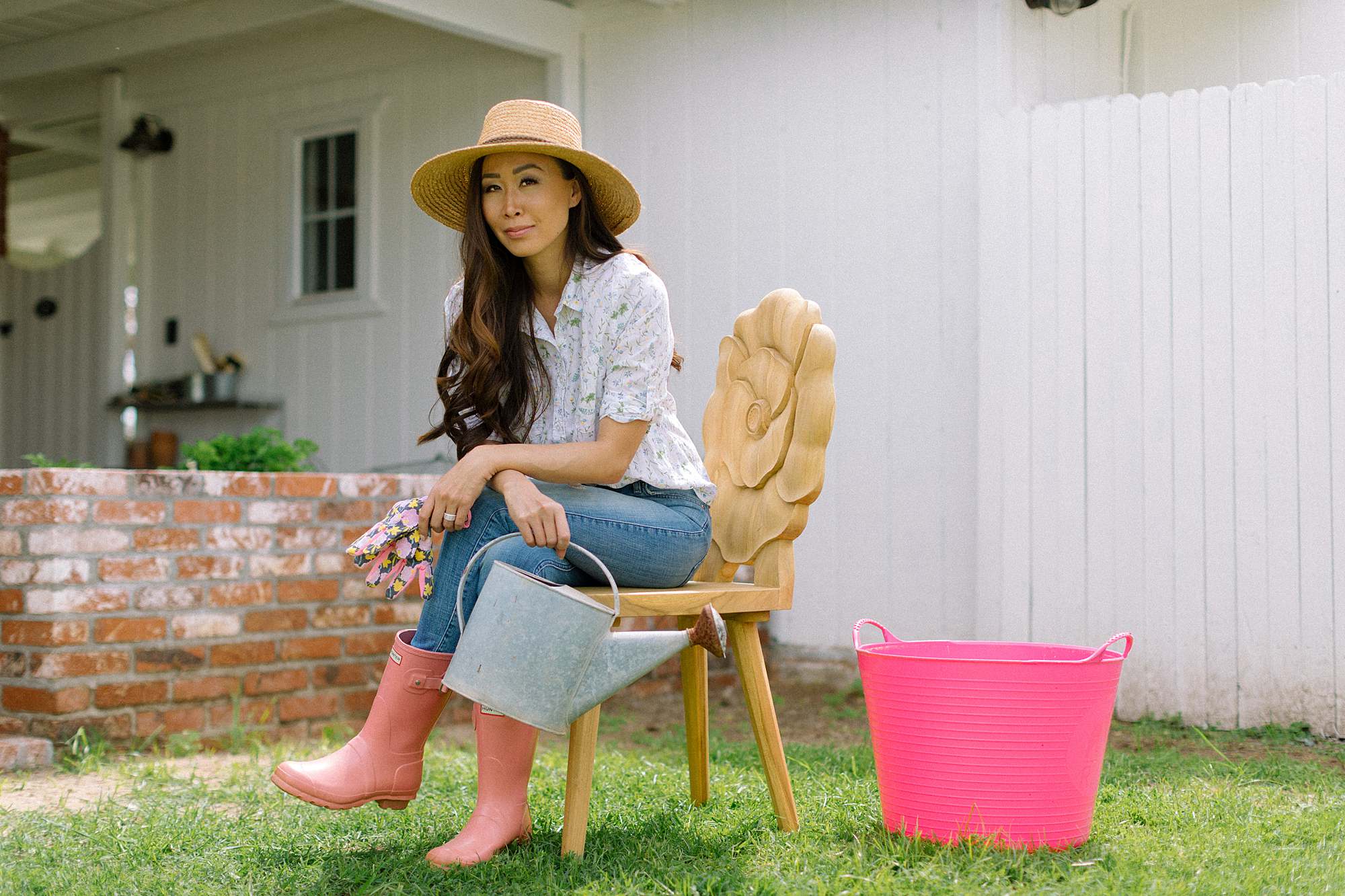 teak floral chair rose poppy gardener's backyard, garden lifestyle blogger Diana Elizabeth in garden hat, gloves and old watering can