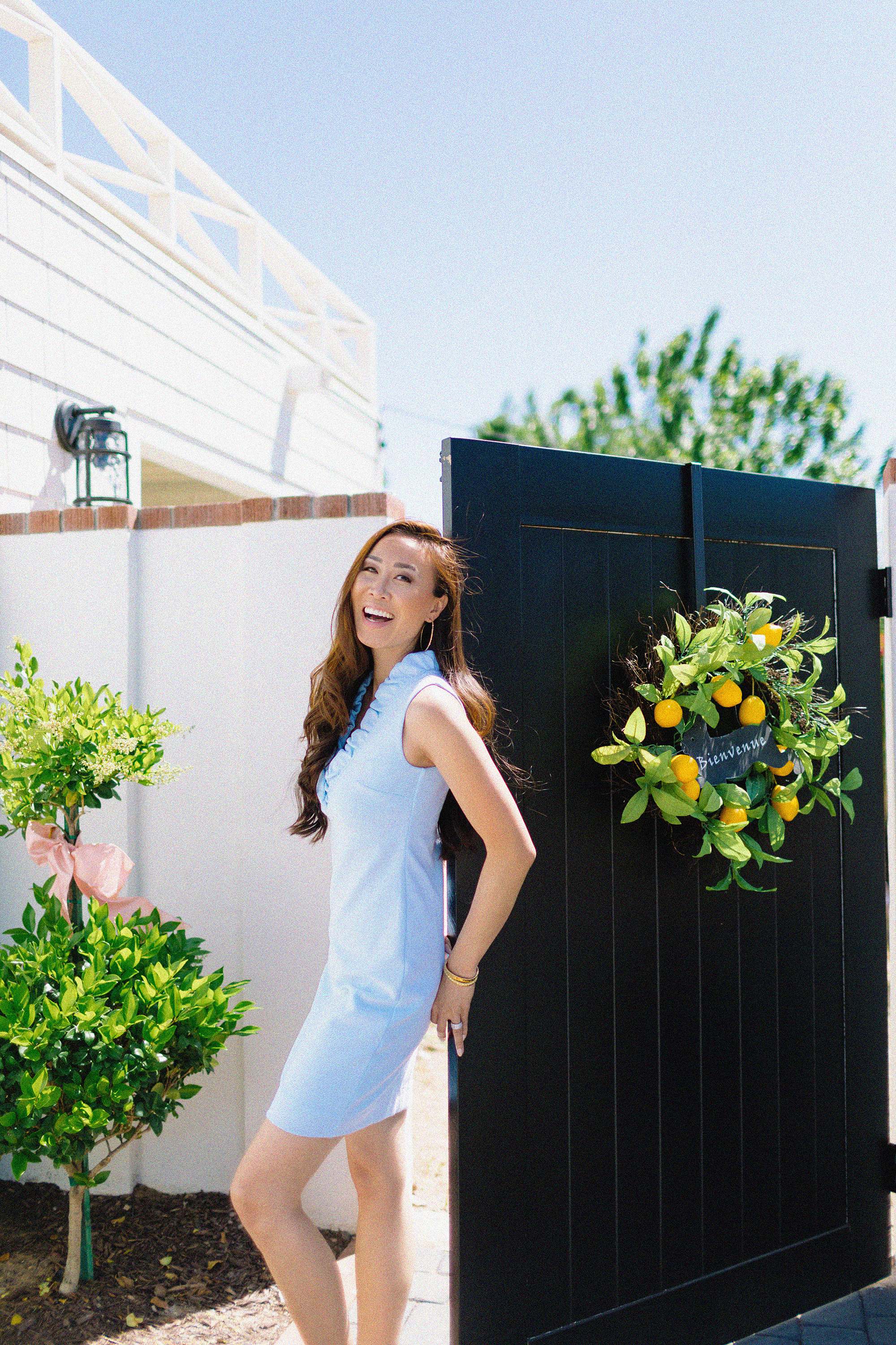 Lilly Pulitzer TISBURY SHIFT DRESS ruffle blue spring dress on blogger in front of black gate going into garden