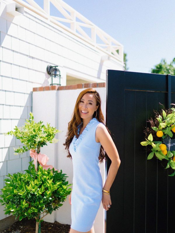 Lilly Pulitzer TISBURY SHIFT DRESS ruffle blue spring dress on blogger in front of black gate going into garden