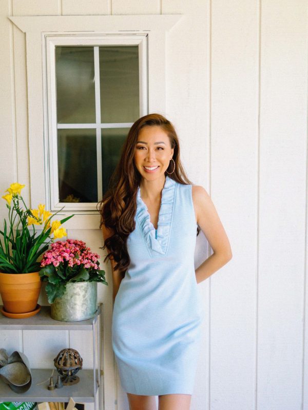 Lilly Pulitzer TISBURY SHIFT DRESS light blue ruffle neck dress details - spring dress looks, lifestyle blogger Diana Elizabeth leaning against the white wall with potted flowers #springdresses #lillypulitzer