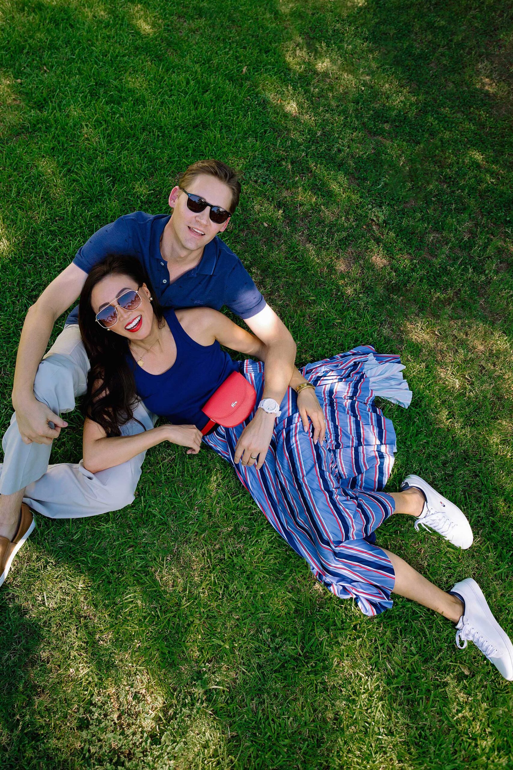 lacoste clothing couple photo in grass pose