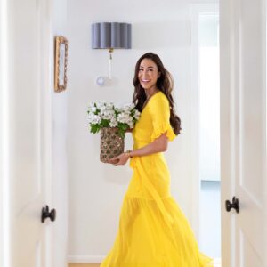 yellow flowy dress waking in hallway with flowers lifestyle and home blogger Diana Elizabeth based in Phoenix Arizona