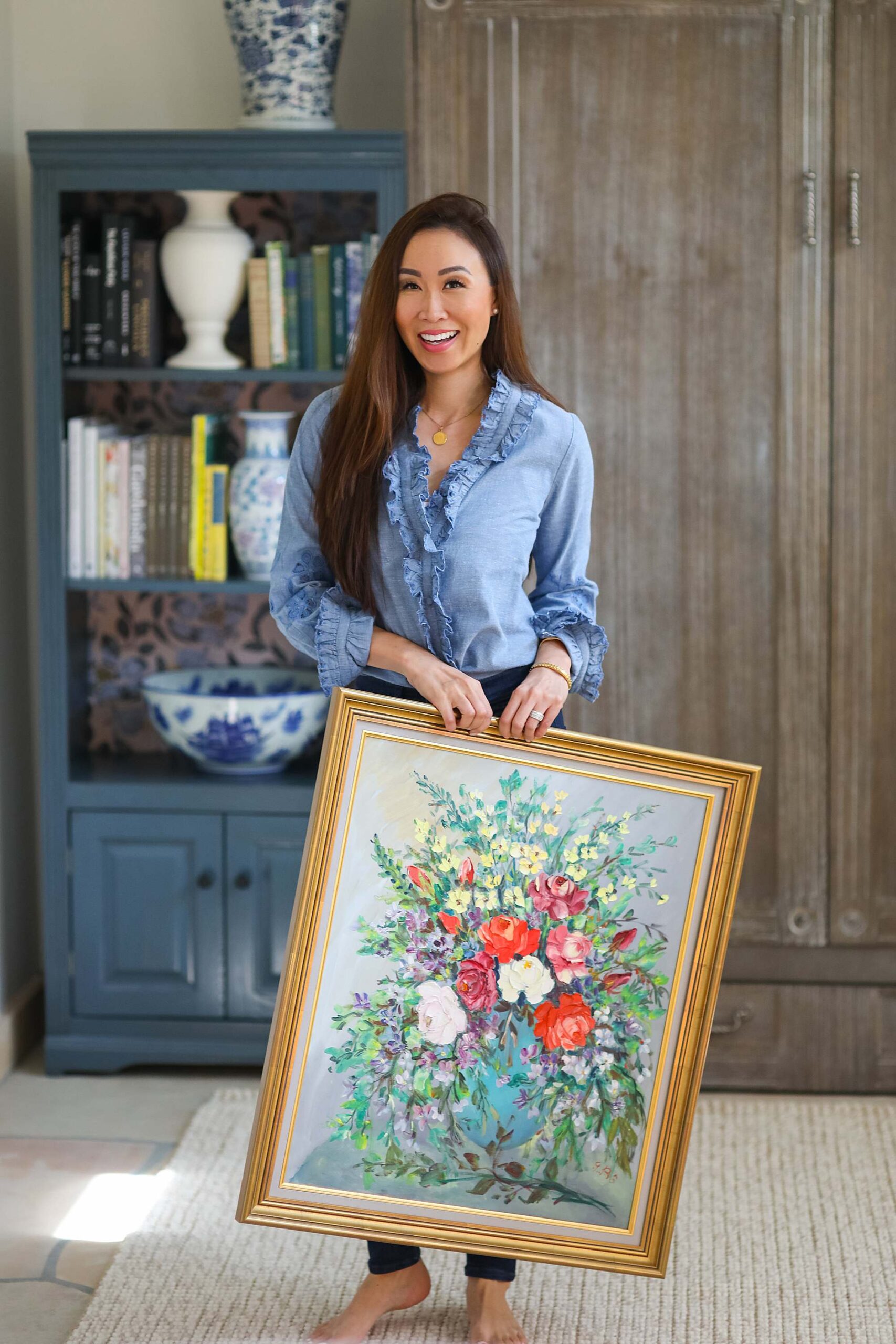 antiquing, thrifting, and buying new like at home goods, what do I like to buy and where // holding antique floral oil on canvas painting - home and lifestyle blogger