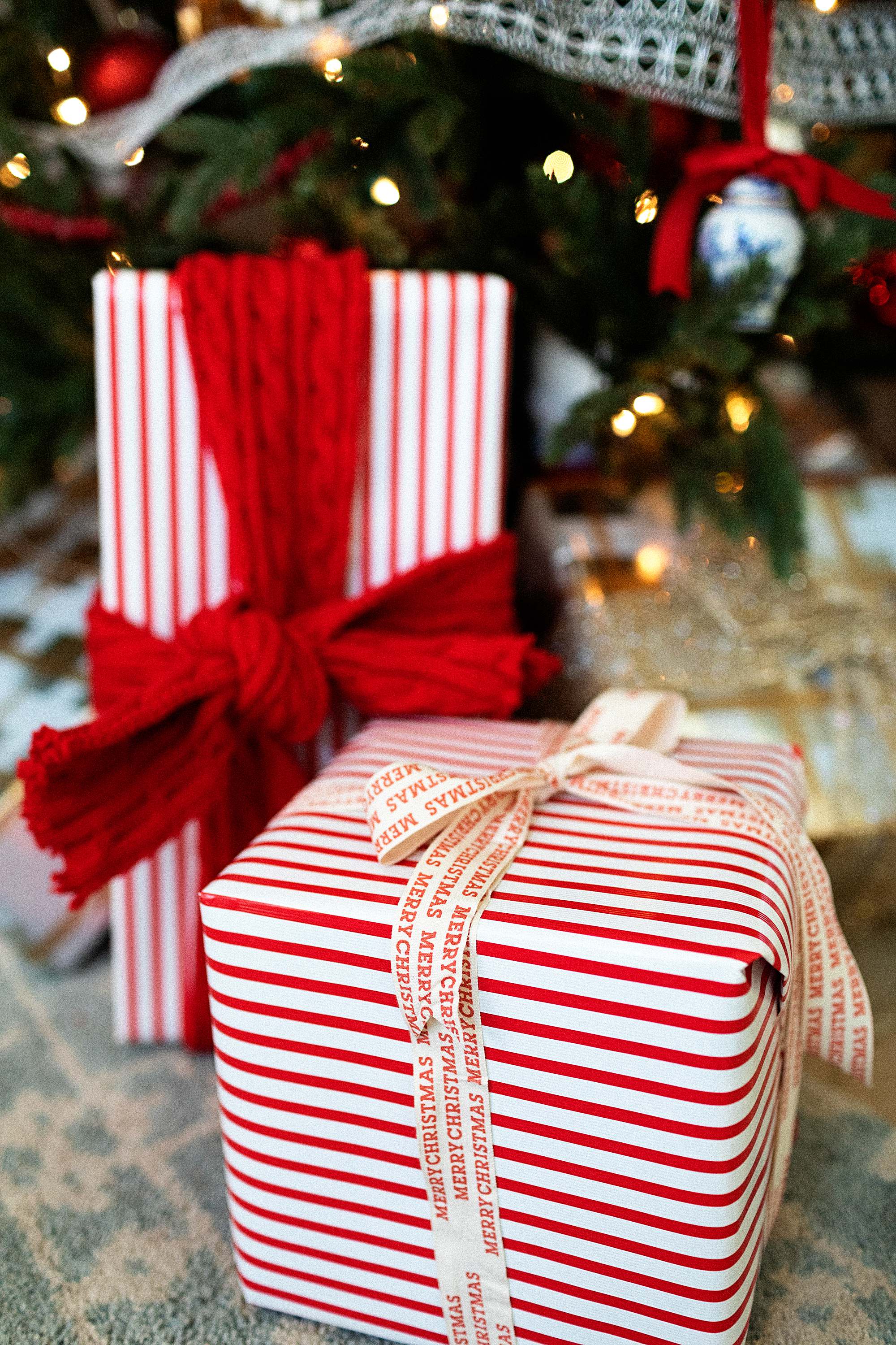 red white stripe Christmas presents under the Christmas tree 