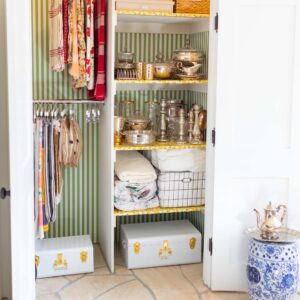 an entertaining closet for the hostess right off the dining room, organize linens and tablecloths and placements as well as serveware - it also serves as a guest closet. #organization Wallpaper closets #removablewallpaper