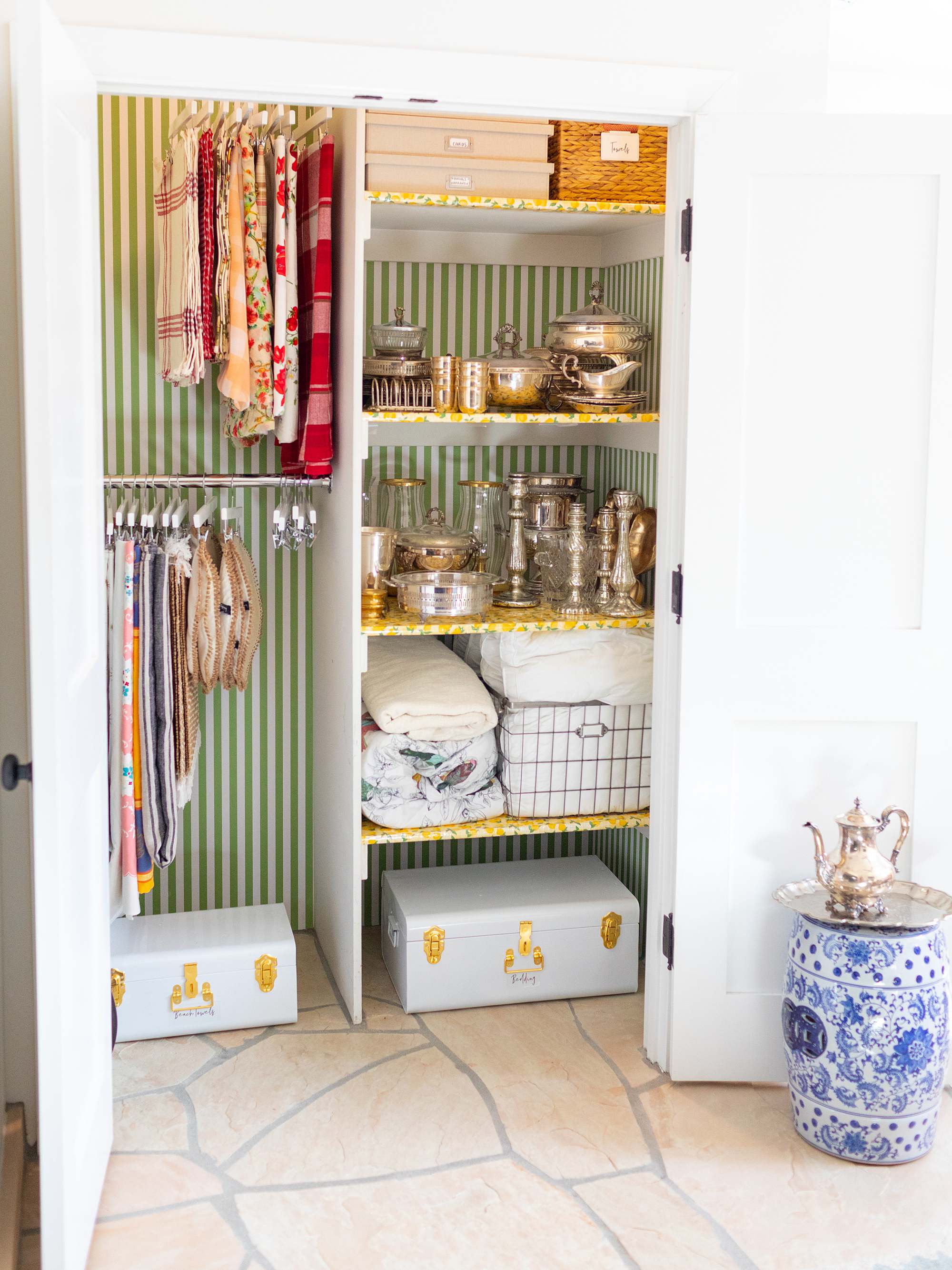 an entertaining closet for the hostess right off the dining room, organize linens and tablecloths and placements as well as serveware - it also serves as a guest closet. #organization Wallpaper closets #removablewallpaper