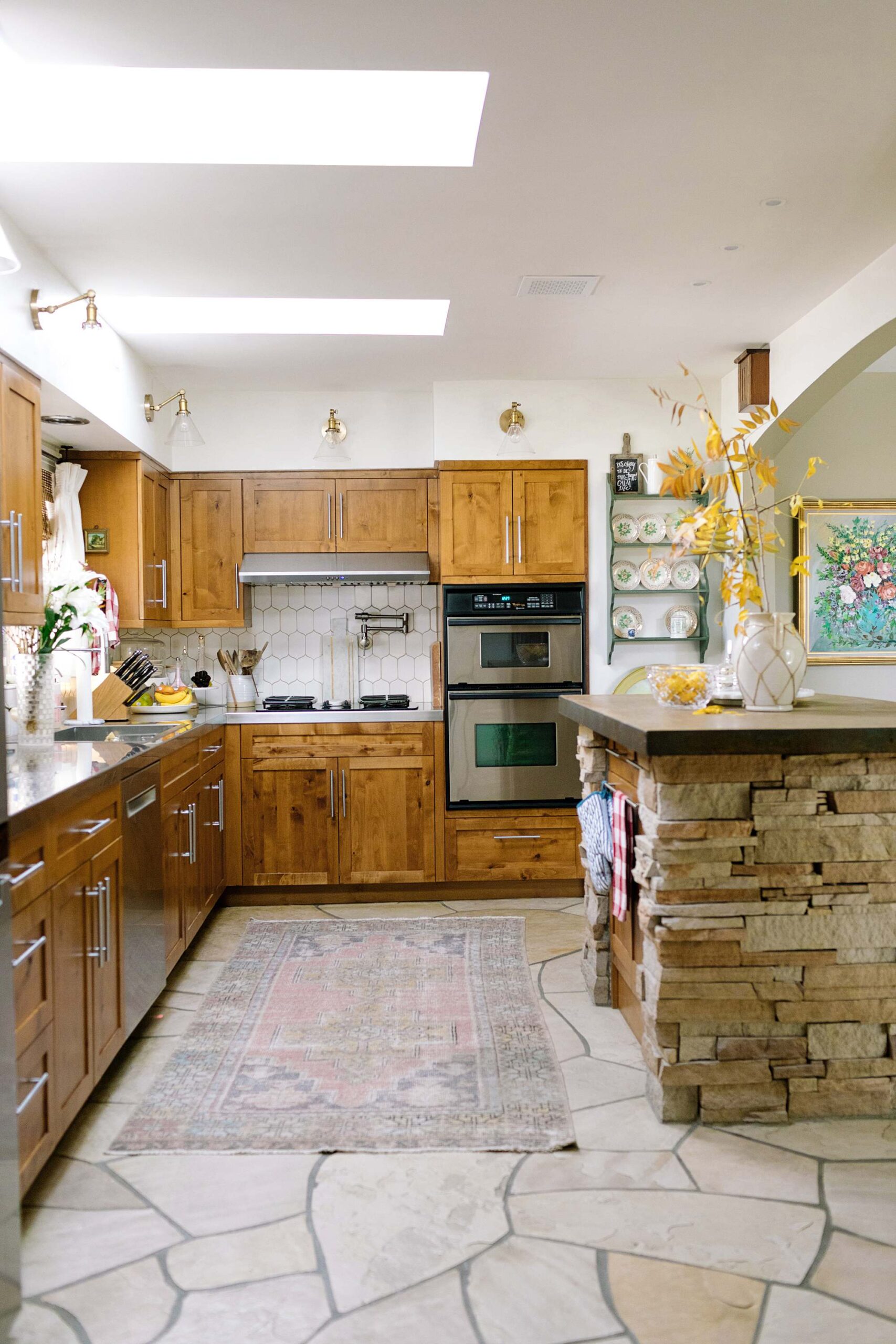 kitchen wall sconces clear glass flagstone floors, natural wood stained cabinets shaker style