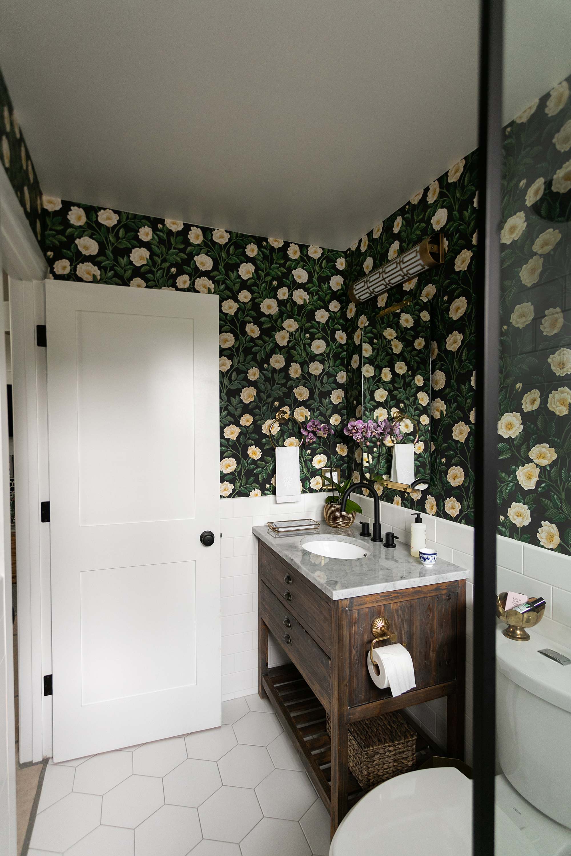 dark green floral wallpaper by Cole and sons, post about making your guest bath unique and comfortable 