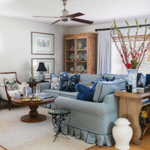 all American living room blue and white blue couch with contrast welt and pleated skirt grandmillennial traditional decoration living room