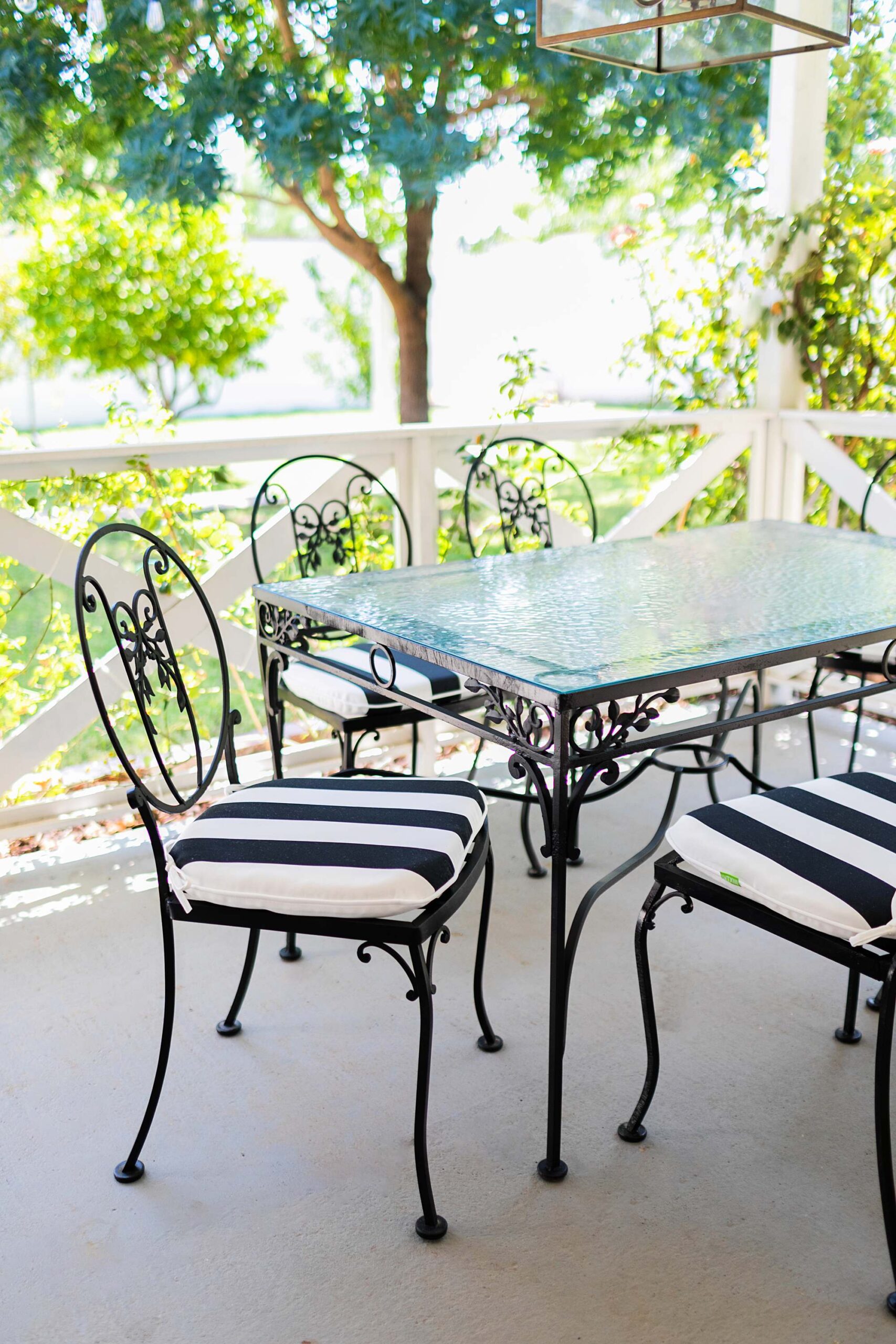 iron mid century modern grand millennial style outdoor table patio set with fresh black and white cushions from amazon - glass top phoenix lifestyle blogger Diana Elizabeth