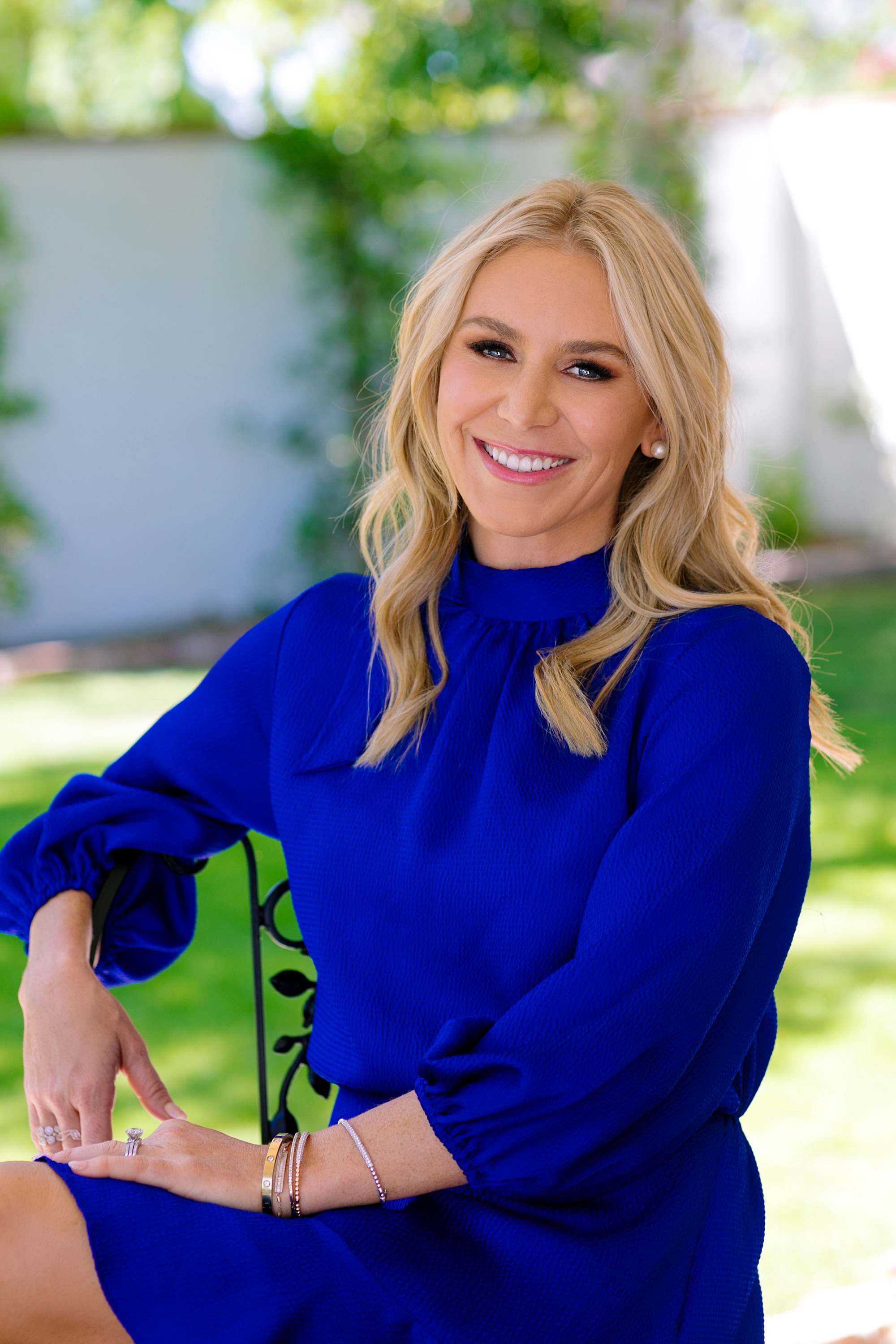 bright blue dress woman sitting in chair for real estate headshot phoenix scottsdale